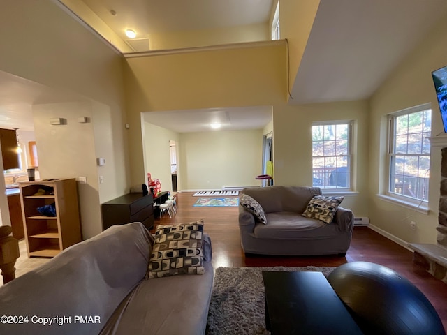 living room with high vaulted ceiling, baseboards, and wood finished floors