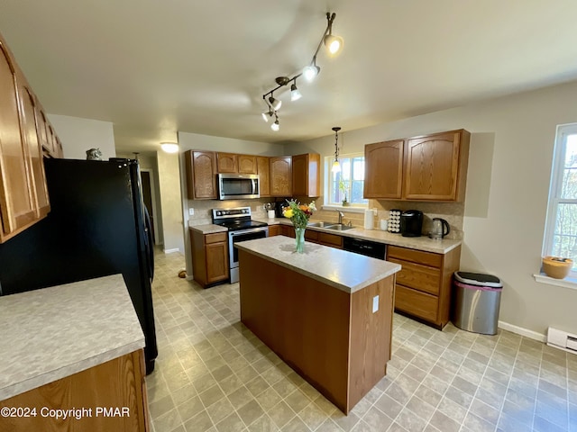 kitchen with a center island, light countertops, decorative backsplash, brown cabinets, and black appliances