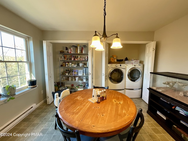 tiled dining room with a notable chandelier, baseboards, baseboard heating, and washer and dryer