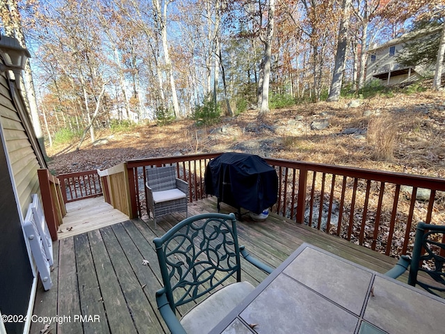 wooden terrace featuring area for grilling