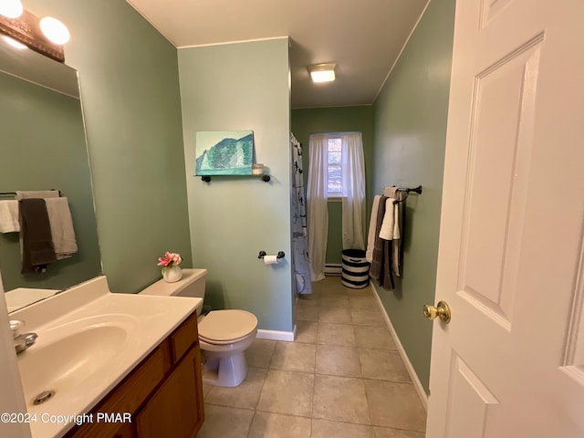 bathroom with baseboards, vanity, toilet, and tile patterned floors