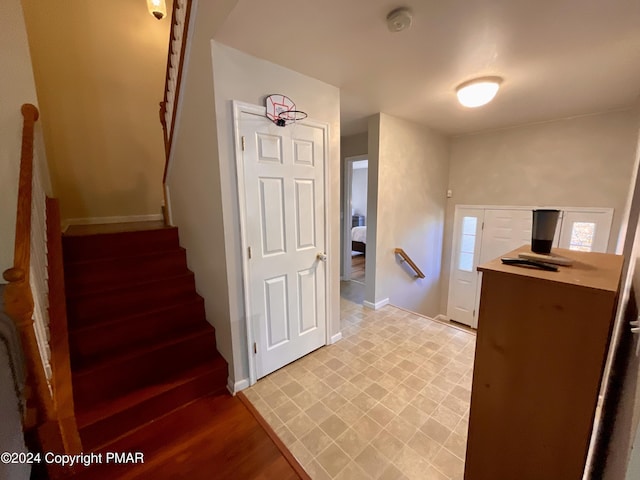 staircase featuring baseboards