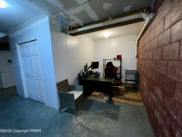 office featuring concrete block wall and concrete floors