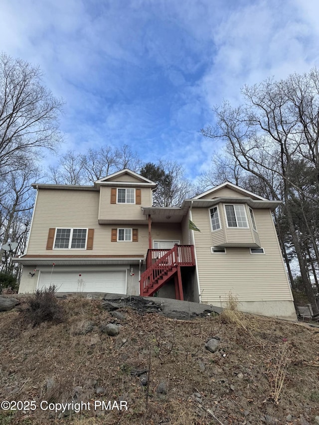 view of front facade with a garage and stairs