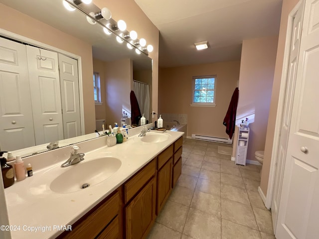 bathroom with toilet, a baseboard radiator, double vanity, and a sink