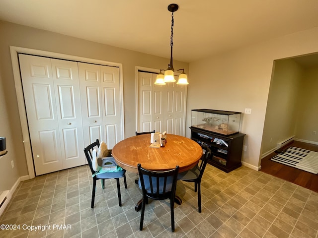 dining space with baseboards and a notable chandelier