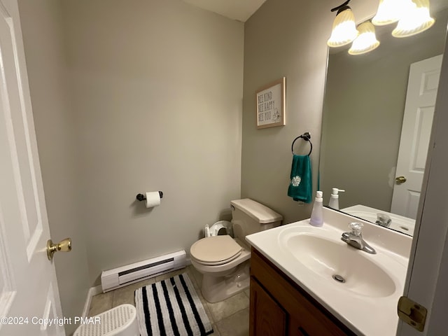 bathroom featuring toilet, tile patterned flooring, a baseboard heating unit, and vanity