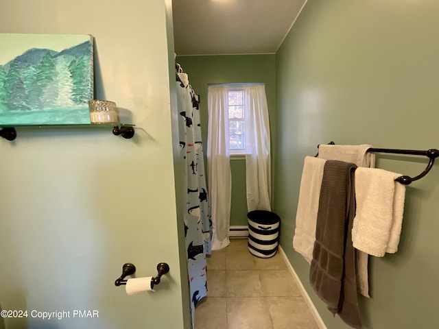 full bath featuring a baseboard heating unit, a shower with curtain, tile patterned flooring, and baseboards