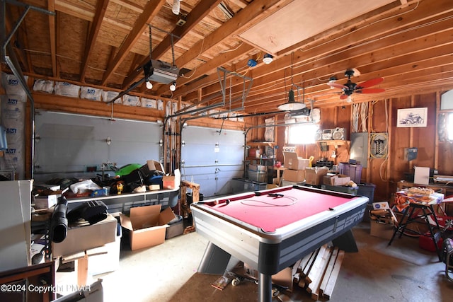 recreation room with a garage, pool table, ceiling fan, and concrete flooring