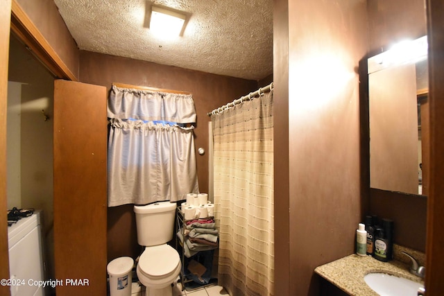 bathroom with a textured ceiling, vanity, toilet, and a shower with curtain