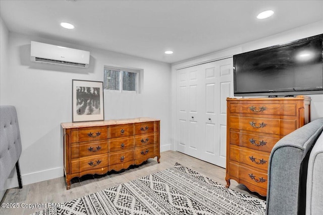 9871 Deerwood Dr, Tobyhanna, PA 18466 - bedroom featuring a wall mounted AC, light wood finished floors, a closet, baseboards, and recessed lighting