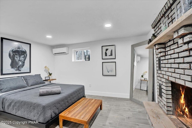 9871 Deerwood Dr, Tobyhanna, PA 18466 - bedroom with a brick fireplace, recessed lighting, a wall mounted AC, baseboards, and light wood finished floors