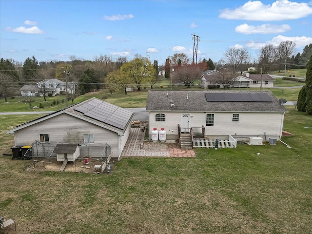 3954 Cedar Dr, Walnutport, PA 18088 - back of house with roof mounted solar panels, a yard, and an outdoor structure