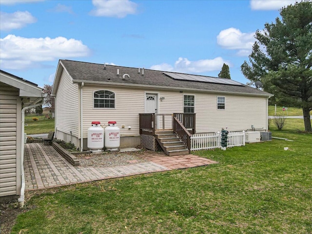 3954 Cedar Dr, Walnutport, PA 18088 - back of house featuring a lawn, roof mounted solar panels, a patio, and roof with shingles