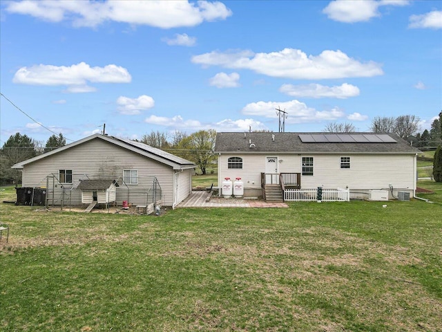 3954 Cedar Dr, Walnutport, PA 18088 - rear view of property featuring solar panels and a lawn