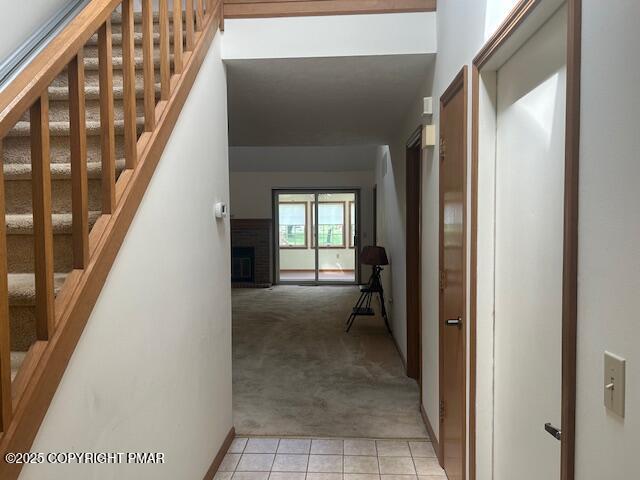 109 Duck Hollow Cir, Stroudsburg, PA 18360 - corridor featuring light carpet, stairway, and light tile patterned floors