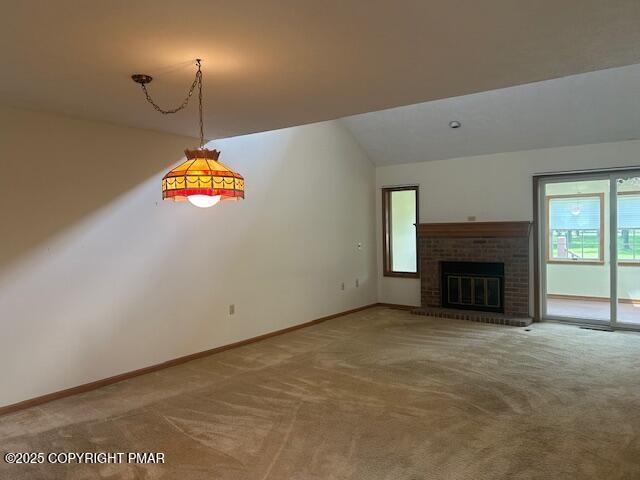 109 Duck Hollow Cir, Stroudsburg, PA 18360 - unfurnished living room with carpet, healthy amount of natural light, vaulted ceiling, and a fireplace