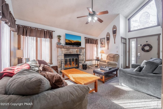 living room featuring a ceiling fan, a textured ceiling, a stone fireplace, carpet floors, and high vaulted ceiling