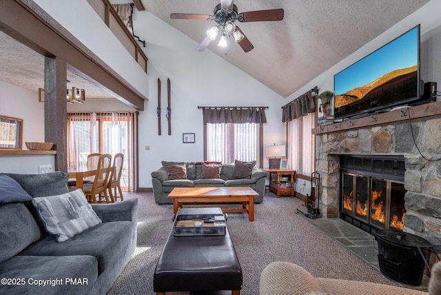 living room featuring carpet floors, a healthy amount of sunlight, a stone fireplace, and a textured ceiling