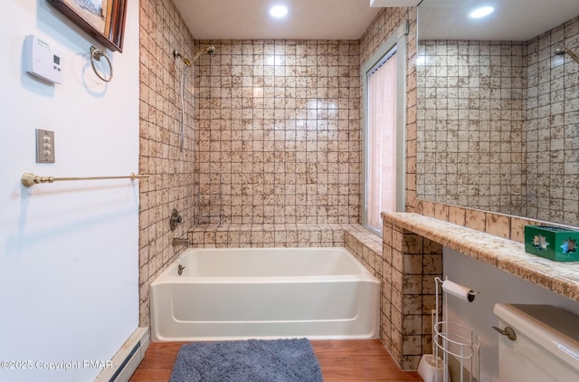 full bathroom with toilet, washtub / shower combination, and wood finished floors