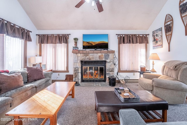 living area featuring carpet floors, vaulted ceiling, a fireplace, and a ceiling fan