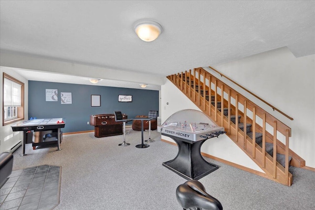 rec room with carpet, a textured ceiling, baseboards, and a baseboard radiator
