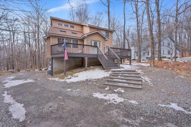 view of front of property with stairway and a wooden deck