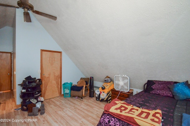 bedroom with wood finished floors, a ceiling fan, and vaulted ceiling