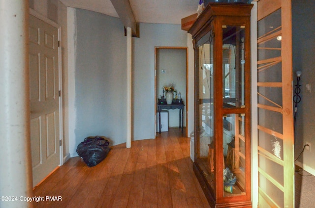 corridor with hardwood / wood-style flooring