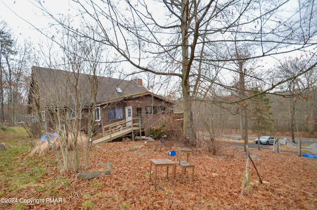 exterior space with a wooden deck and a chimney