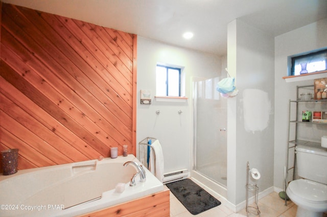 bathroom with a baseboard heating unit, a shower stall, toilet, and a garden tub