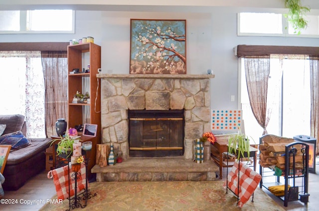 living room featuring a stone fireplace