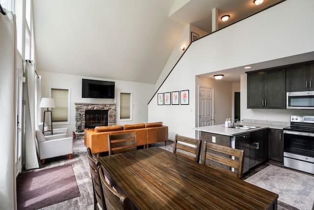 4130 Mill Creek Dr, Cresco, PA 18326 - dining area with high vaulted ceiling, a fireplace, and dark wood finished floors