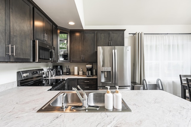 4130 Mill Creek Dr, Cresco, PA 18326 - kitchen with stainless steel appliances, dark brown cabinets, glass insert cabinets, recessed lighting, and light stone counters