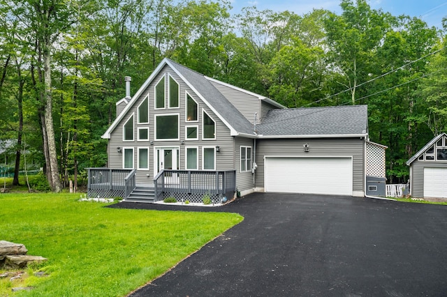 4130 Mill Creek Dr, Cresco, PA 18326 - chalet / cabin featuring driveway, a garage, a shingled roof, a front lawn, and a deck