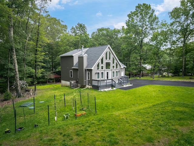 4130 Mill Creek Dr, Cresco, PA 18326 - view of side of home with roof with shingles, a lawn, and a wooded view