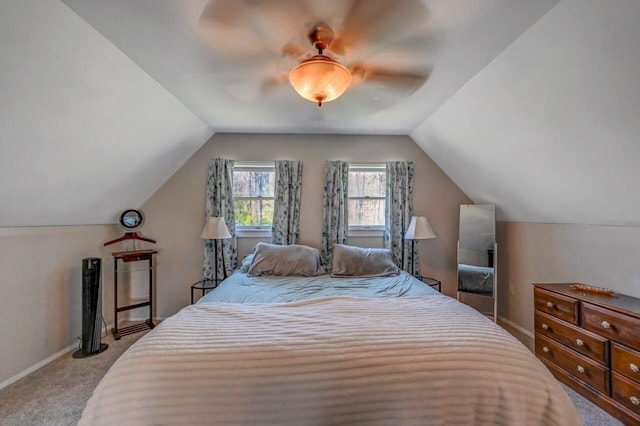 bedroom with carpet flooring, a ceiling fan, baseboards, and vaulted ceiling