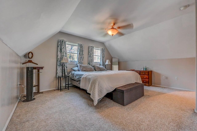 bedroom with baseboards, carpet, a ceiling fan, and lofted ceiling
