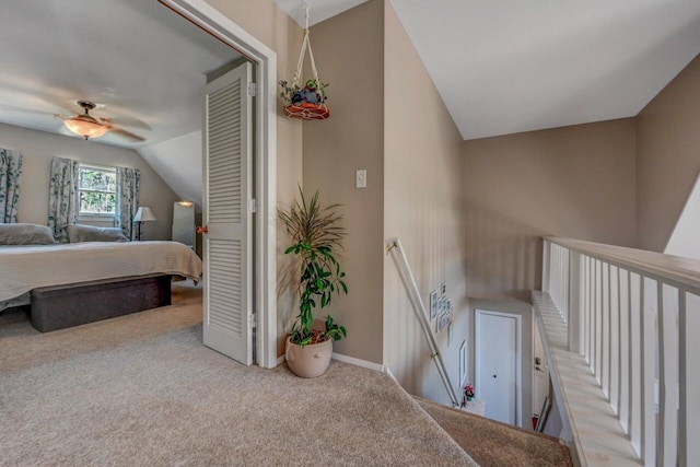 bedroom with carpet floors, baseboards, and vaulted ceiling