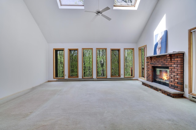 476 Hyland Dr, East Stroudsburg, PA 18301 - unfurnished living room featuring carpet flooring, ceiling fan, a fireplace, high vaulted ceiling, and a skylight