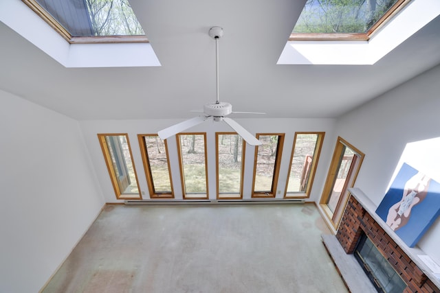 476 Hyland Dr, East Stroudsburg, PA 18301 - unfurnished living room featuring a ceiling fan, a fireplace, carpet flooring, and lofted ceiling with skylight