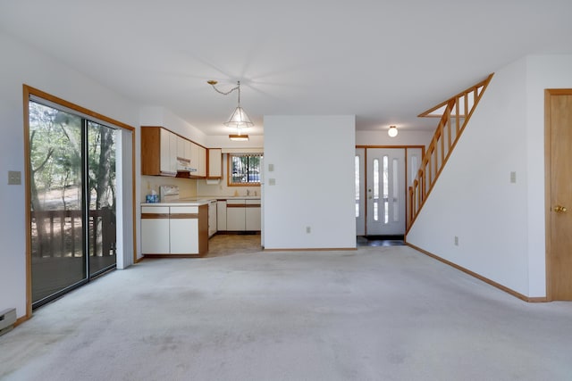 476 Hyland Dr, East Stroudsburg, PA 18301 - unfurnished living room featuring baseboards, light colored carpet, and a wealth of natural light