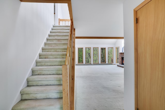 476 Hyland Dr, East Stroudsburg, PA 18301 - stairs featuring carpet floors, a high ceiling, a brick fireplace, and a healthy amount of sunlight