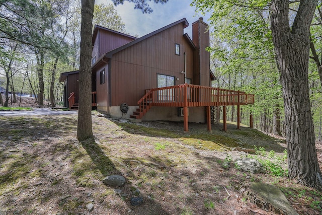 476 Hyland Dr, East Stroudsburg, PA 18301 - view of side of home featuring a chimney, stairway, and a deck