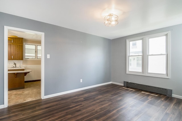 247 S 7th St, Lehighton, PA 18235 - empty room featuring a baseboard radiator and dark wood-style floors