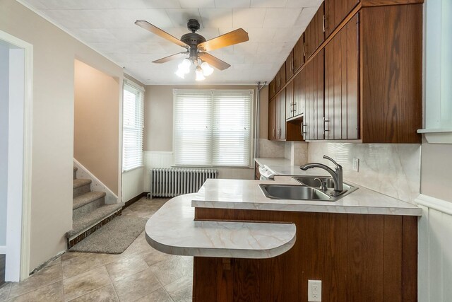 247 S 7th St, Lehighton, PA 18235 - kitchen with radiator, light countertops, ceiling fan, a peninsula, and a wainscoted wall