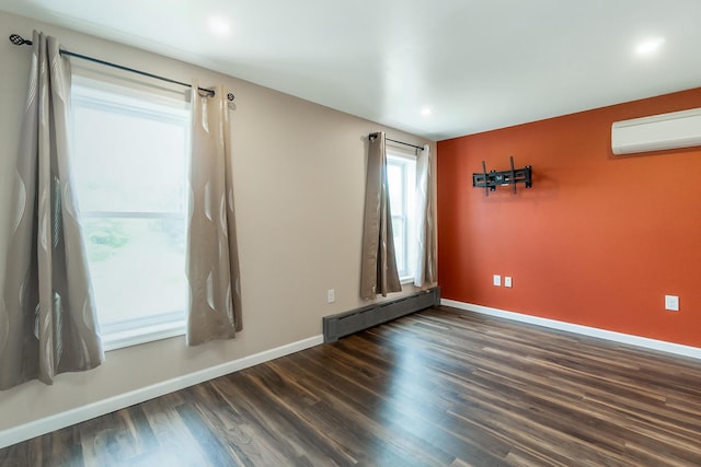 247 S 7th St, Lehighton, PA 18235 - spare room with baseboard heating, a wall mounted AC, dark wood-style floors, and recessed lighting