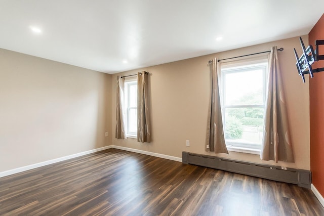 247 S 7th St, Lehighton, PA 18235 - spare room featuring a baseboard heating unit, dark wood-style floors, healthy amount of natural light, and recessed lighting