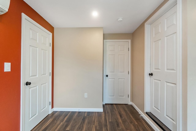 247 S 7th St, Lehighton, PA 18235 - unfurnished bedroom featuring dark wood-type flooring and a wall unit AC