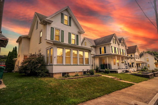 247 S 7th St, Lehighton, PA 18235 - back of house at dusk with covered porch and a lawn